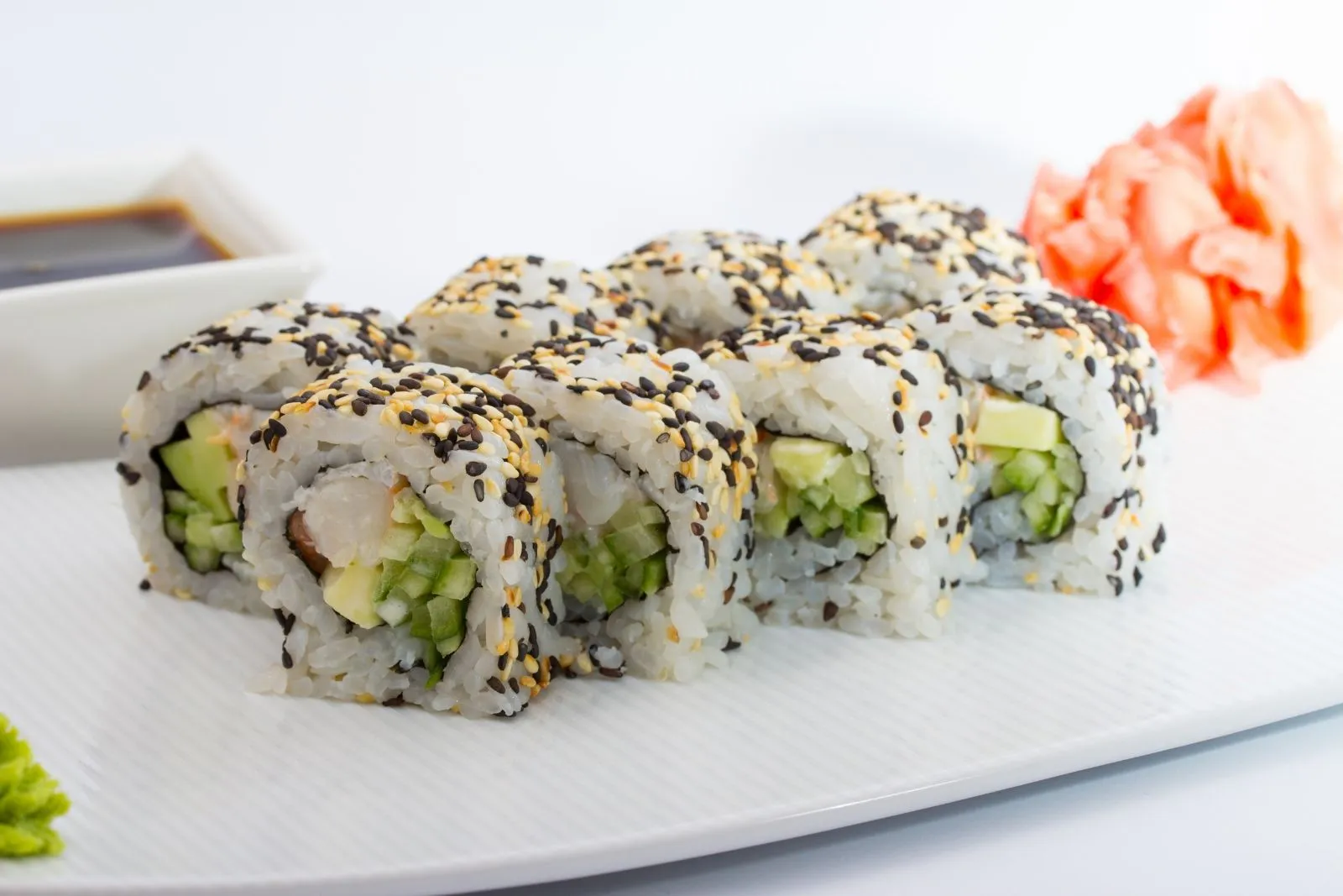 Sesame seed covered shrimp avocado maki roll with pickled ginger and wasabi at SUSHI 88, a Japanese Restaurant in New York
